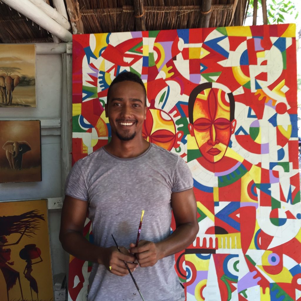 Artist Kevin Peters poses with a cubist painting he created in Diana Beach, Kenya. (Photo by Kevin Grant/GroundTruth)