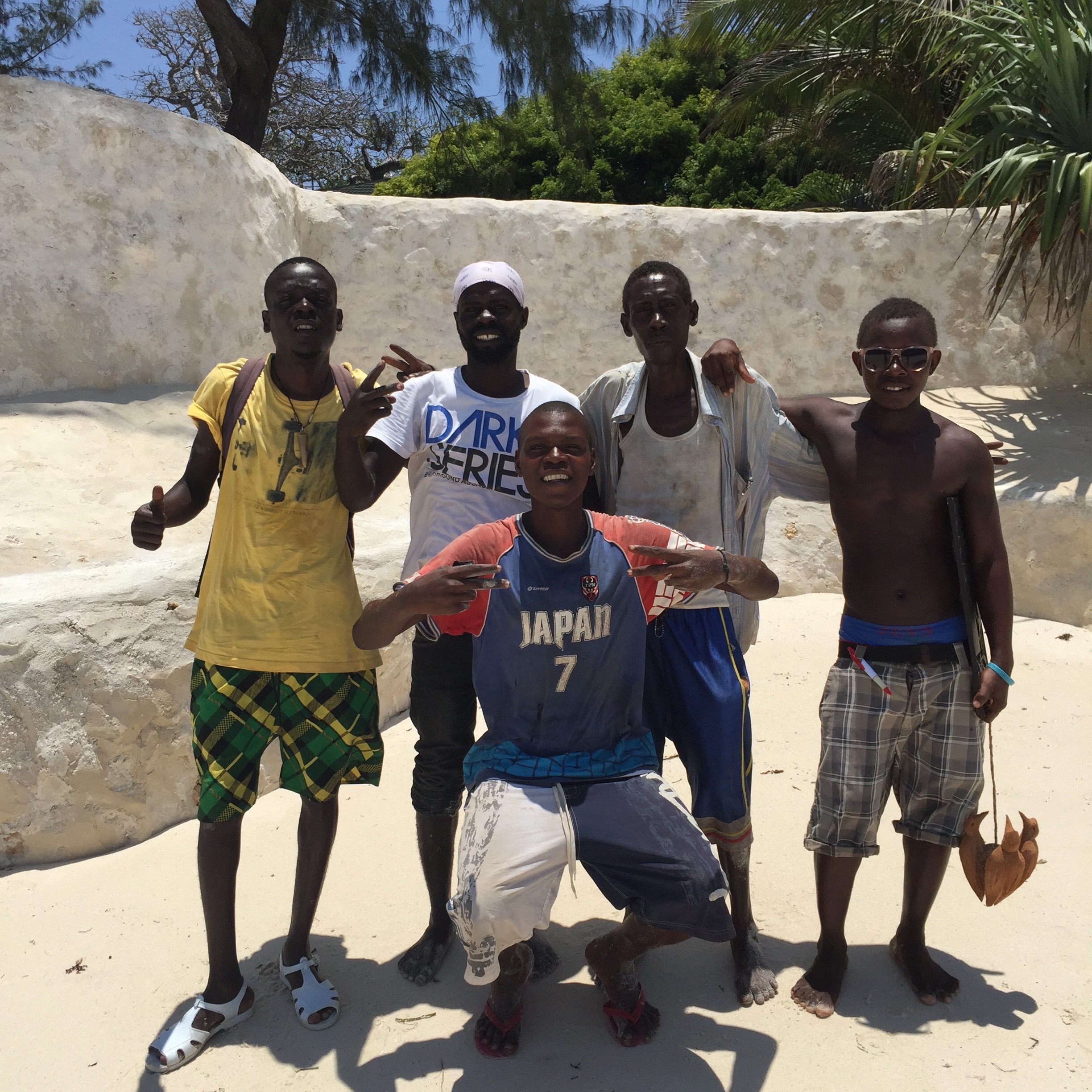 Five Sea Safari crew members pose for a group photo in Diana Beach, Kenya. (Photo by Kevin Grant/GroundTruth)