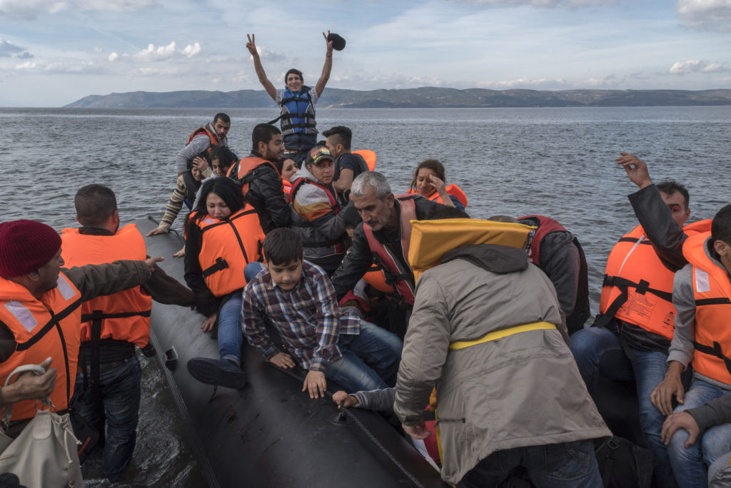 An inflatable boat with Syrian Refugees arrives safely to Skala Sykamias, Lesvos island, Greece, in 2015. (Photo by Ggia/Wikimedia Commons)
