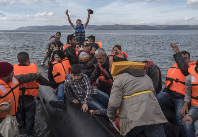 An inflatable boat with Syrian Refugees arrives safely to Skala Sykamias, Lesvos island, Greece, in 2015. (Photo by Ggia/Wikimedia Commons)