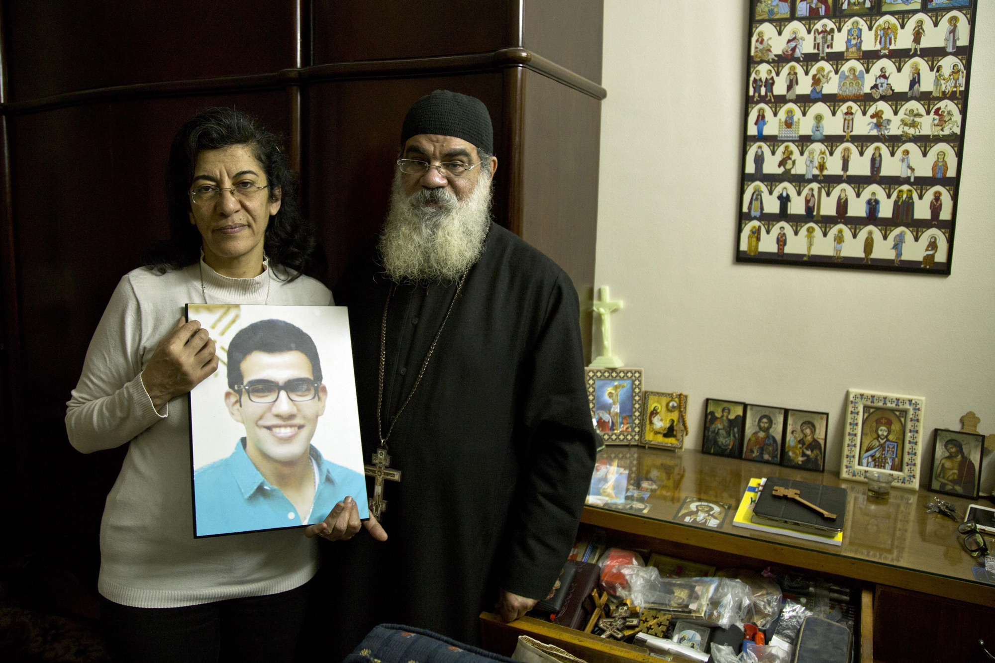 Priest Danial and his wife stand in the room of their son, Beshoy, who died during the suicide bombing in St. George Church in Egypt on Wednesday, April 12, 2017. (Photo by Roger Anis/GroundTruth)