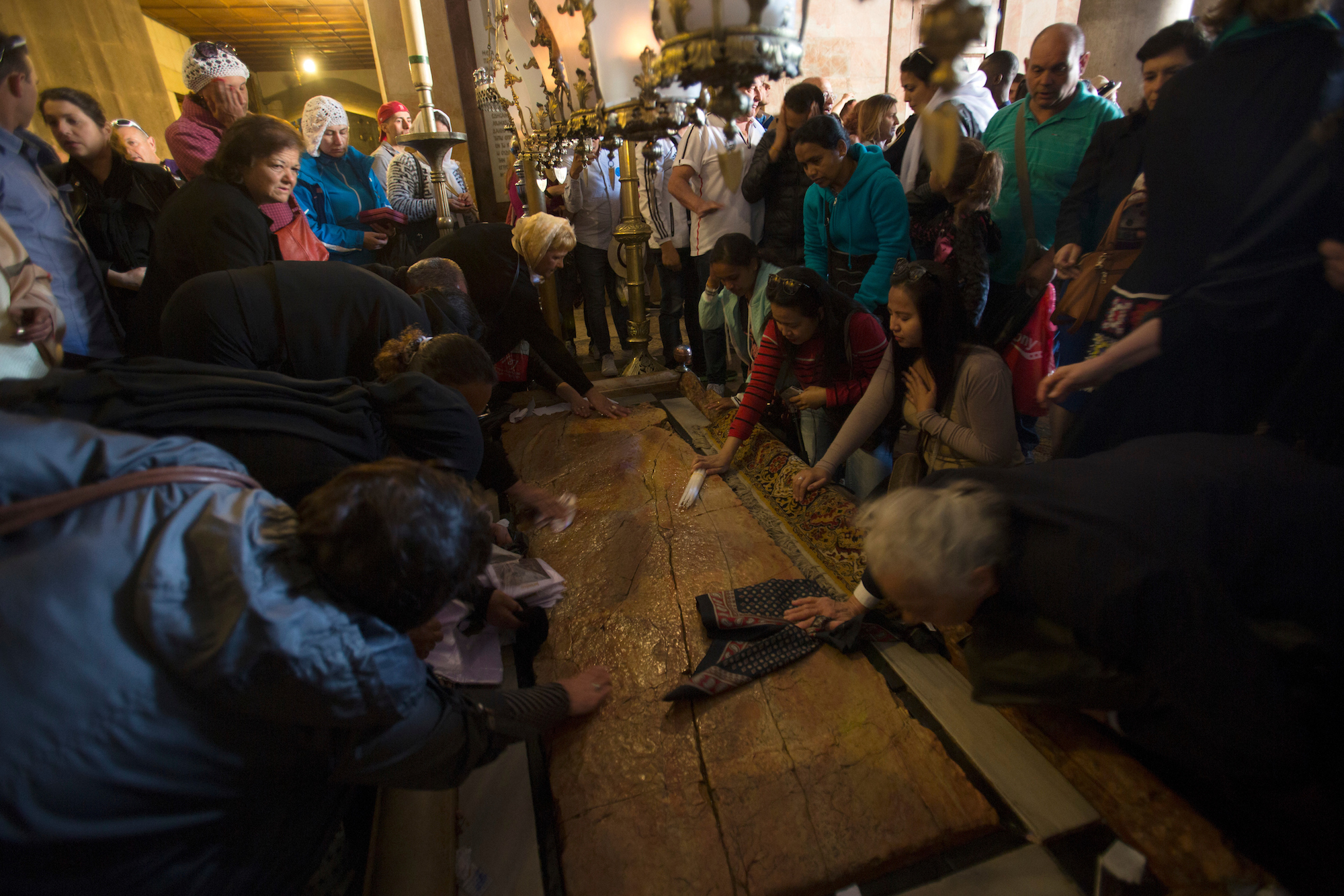 Christian worshippers by the Stone of Unction during the 2017 Easter Sunday celebration at the Church of the Holy Sepulchre, believed by Christians to be the site of the crucifixion and burial of Jesus Christ, in Jerusalem. (Photo by Heidi Levine/ GroundTruth)