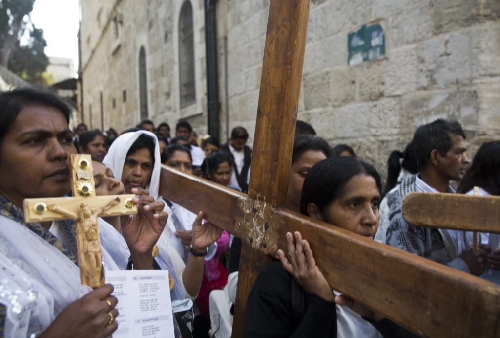 Christian pilgrims from Indonesia carry wooden crosses along Via Dolorosa, or “The Way of Sorrow," in the Old City of Jerusalem on April 14, 2017. Good Friday marks the holy day of remembrance when Jesus was sentenced to death and crucified, and it comes before the celebration of Easter Sunday, when Christian faith holds that Jesus rose from the dead and will come again. (Photo by Heidi Levine)