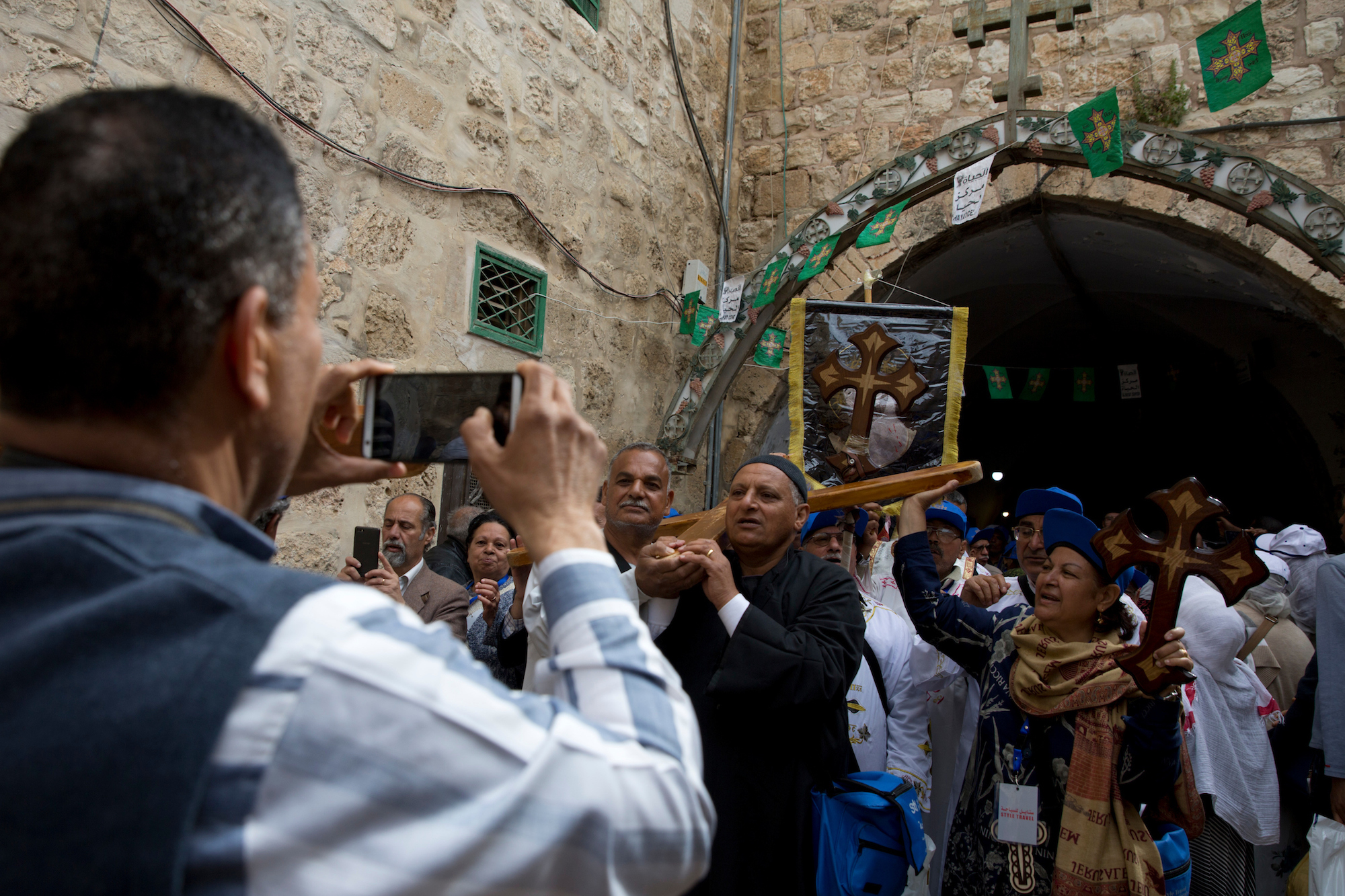 Christian pilgrims walk along the Via Dolorosa, or “The Way of Sorrow" in the Old City of Jerusalem on Good Friday, April 14, 2017. Every year, thousands of Christians from around the world flock to the region to commemorate Easter, but residents say they hardly interact with Palestinian Christians who have carried the faith’s tradition in the Holy Land. (Photo by Heidi Levine/GroundTruth)