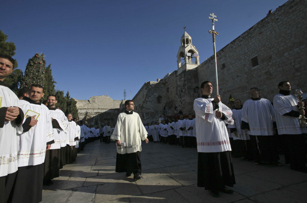 A Catholic clergy walk is held during a procession outside the Church of the Nativity, amid Christmas celebrations in the biblical West Bank city of Bethlehem. Dec. 24, 2017. (Photo by Heidi Levine)
