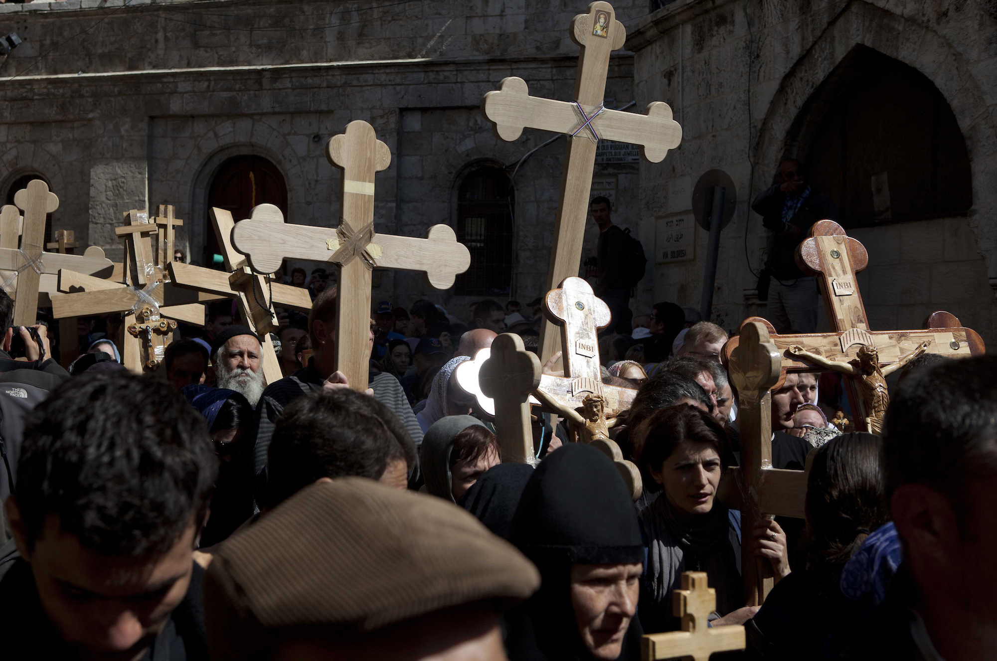 Christian worshippers hold crosses as they take part in the Eastern and Orthodox Church's Good Friday procession in the Old City of Jerusalem on April 13, 2012. Thousands of worshippers retraced the route Jesus took along the Via Dolorosa towards his crucifixion. (Photo by Heidi Levine/GroundTruth)
