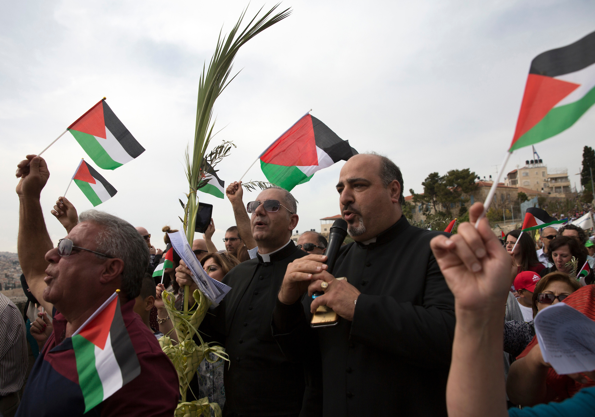 Palestinian Christian Pilgrims celebrate during a Palm Sunday procession on the Mt. of Olives on April 9, 2017. (Photo by Heidi Levine/Sipa Press).