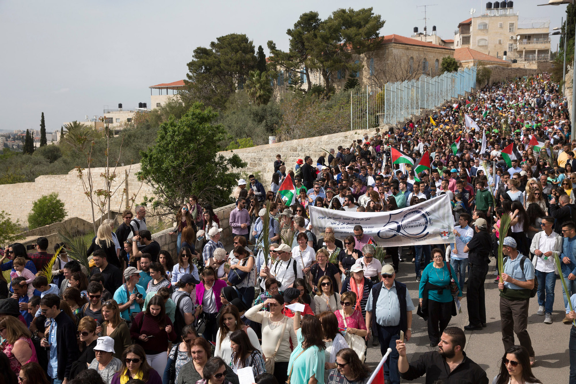Christian Pilgrims celebrate during the Palm Sunday procession on the Mt. of Olives on April 9,2017. (Photo by Heidi Levine/Sipa Press).
