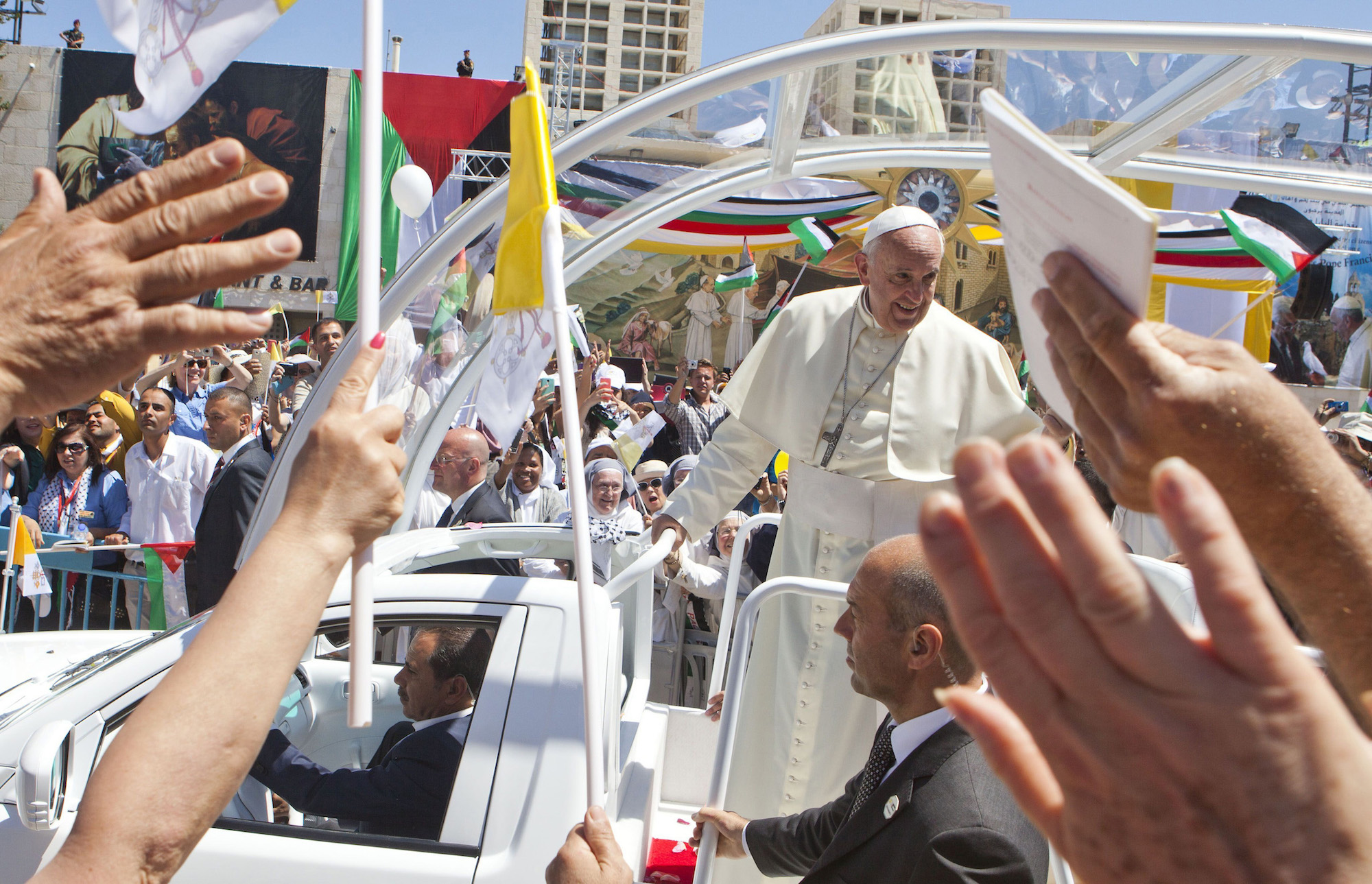 In an open vehicle, Pope Francis arrived in Bethlehem's Manger Square, which was packed with over 10,000 Christian pilgrims on Sunday, May 25, 2014. The visit marked the beginning of his three-day Middle East tour aimed at easing an ancient rift with Orthodox Christians and forging regional peace. (Photo by Heidi Levine/Sipa Press)