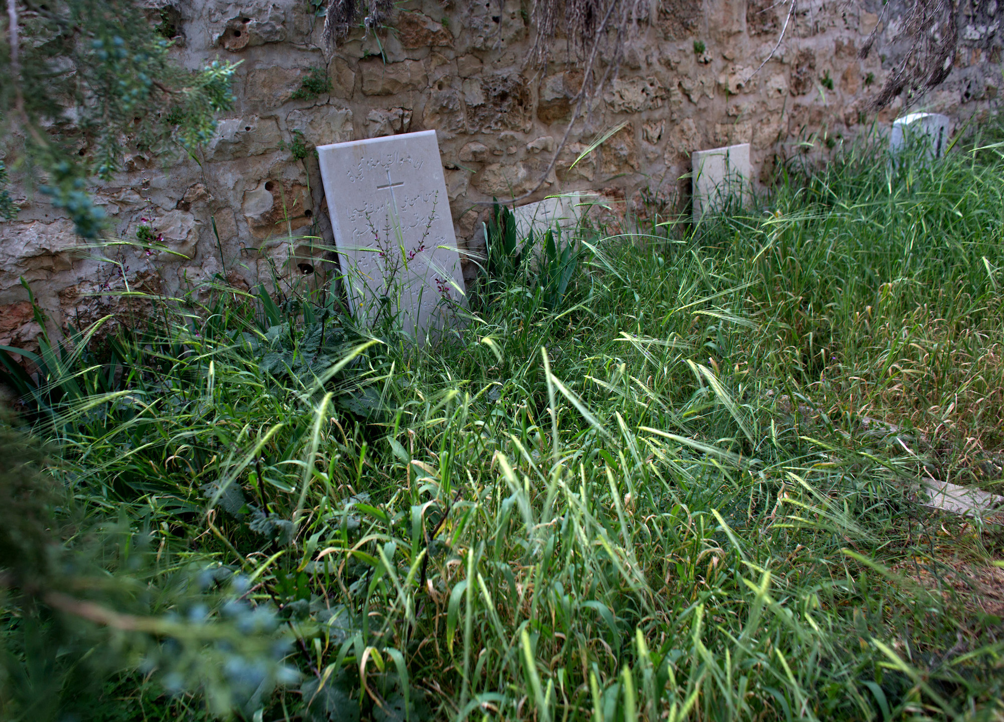 Christian tombstones are seen in a neglected Christian cemetery in the West Bank village of El Qubeibeh, also known as Emmaus. (Photo by Heidi Levine/GroundTruth)