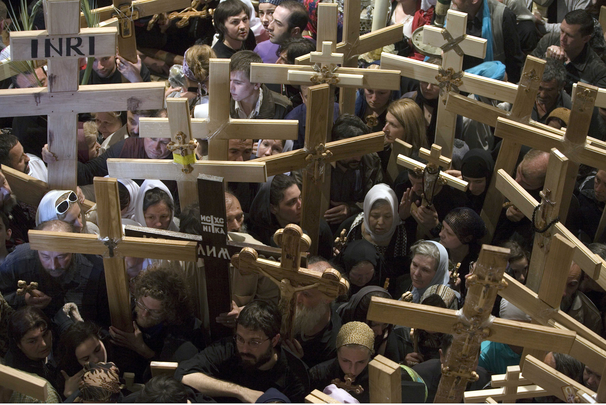 Christian pilgrims inside the Church of the Holy Sepulchre during a Good Friday procession in Jerusalem's Old city on April 2, 2010. Christian worshippers retraced the traditional route Jesus Christ took along the Via Dolorosa to his crucifixion in the Church of the Holy Sepulchre. Christian pilgrims carry crosses inside the Church of the Holy Sepulchre during a Good Friday procession in Jerusalem's Old city April 2, 2010. Christian worshippers retraced the traditional route Jesus Christ took along the Via Dolorosa to his crucifixion in the Church of the Holy Sepulchre. (Photo by Heidi Levine/Sipa Press)