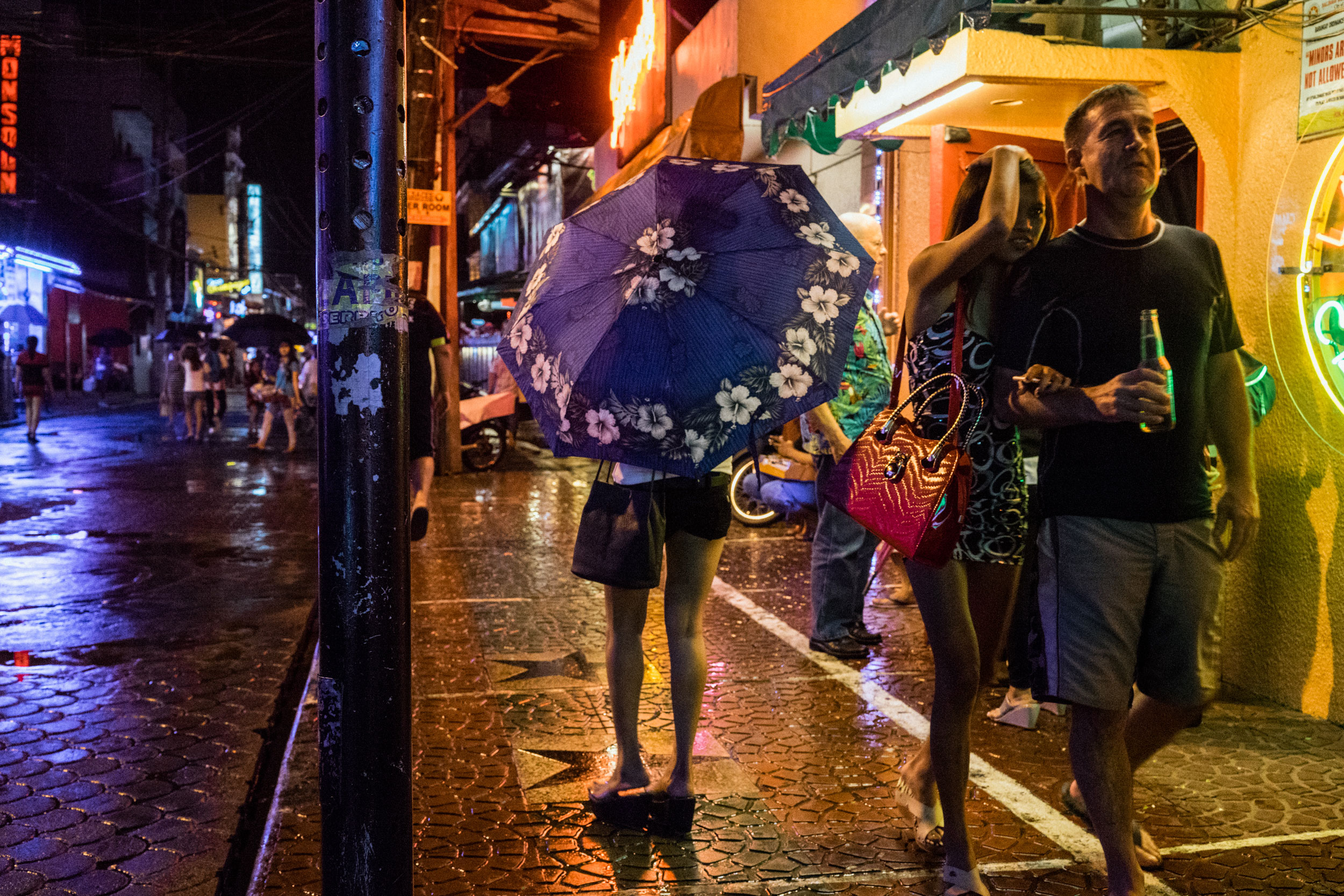 A scene from Fields Avenue, the red light district in Angeles City, notorious for its sex tourism. In the wake of typhoons, women and girls wind up in the sex trade after being displaced by storms. Click on the photo to see the story. (Photo by Hannah Reyes Morales/GroundTruth)