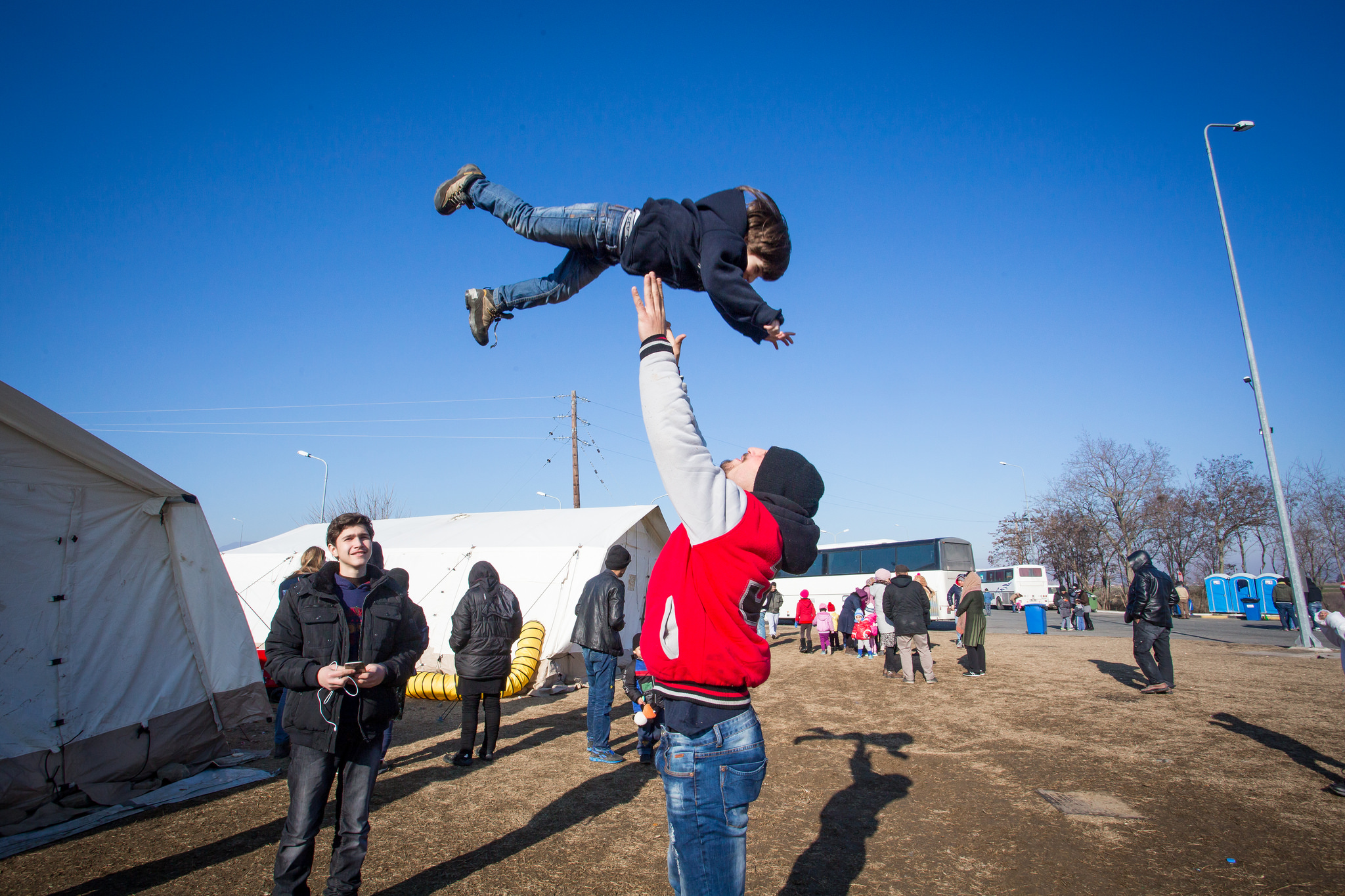 Refugees play at a camp along the Greece-Macedonia border.. (Photo by Natalia Tsoukala and Caritas International/Flickr Creative Commons)