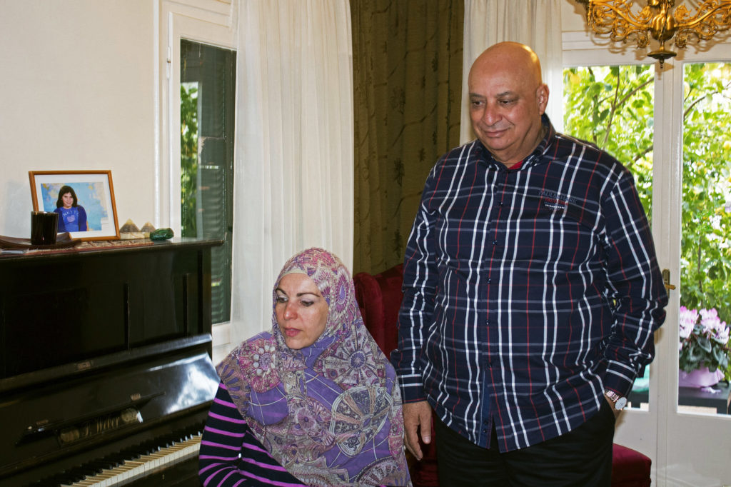 Naim El-Ghandour, activist and president of the Muslim Association of Greece, stands with his wife, Anna, in his home in Athens, Greece. About two weeks ago, he testified against Golden Dawn.  (Photo by Marie Targonski-O’Brien/GroundTruth)