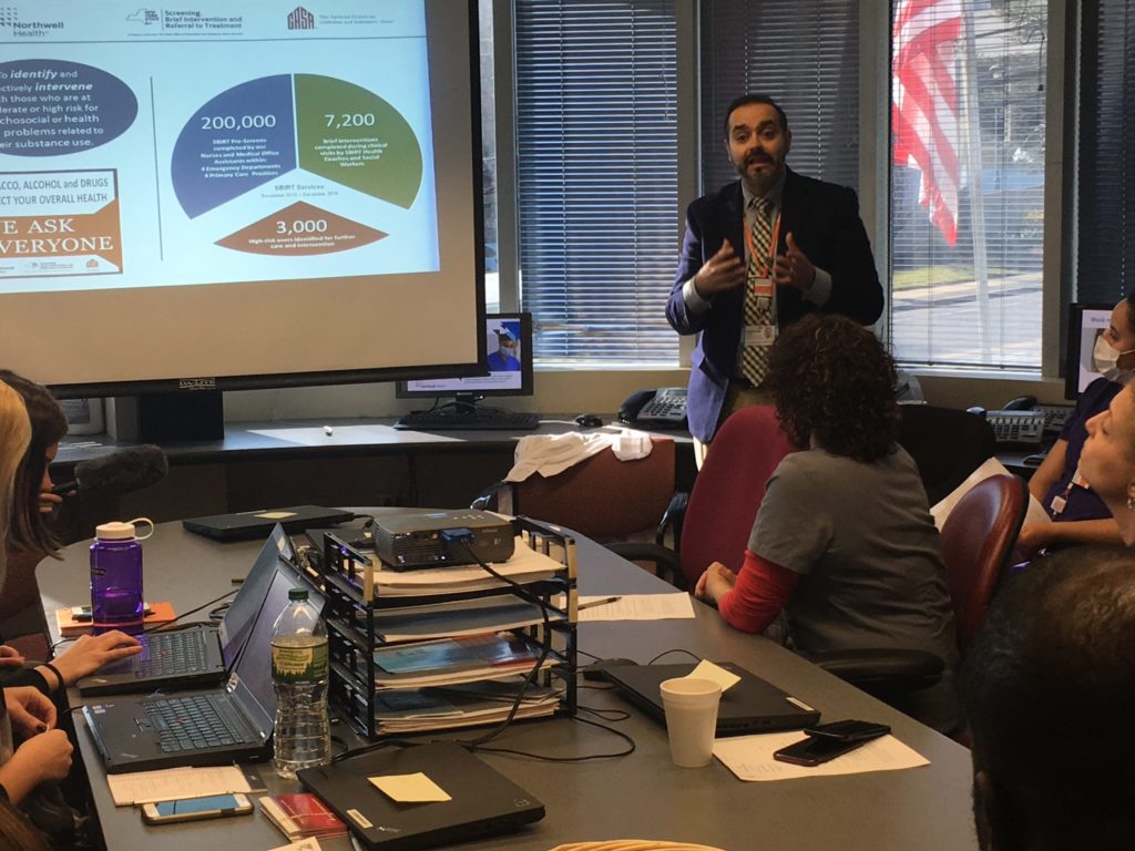 Dr. Sandeep Kapoor leads an SBIRT training seminar at the Division of Internal Medicine, one of Northwell’s pilot sites for the substance use screening process. SBIRT stands for Screening, Brief Intervention, and Referral to Treatment. (Photo by Joaquin Cotler/GroundTruth)