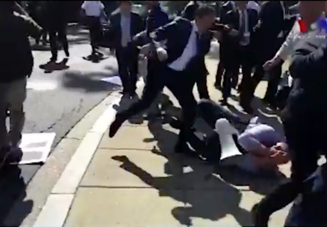 In this screenshot from a video posted on Twitter by VOA Turkish, a man can be seen kicking a protester on the ground.