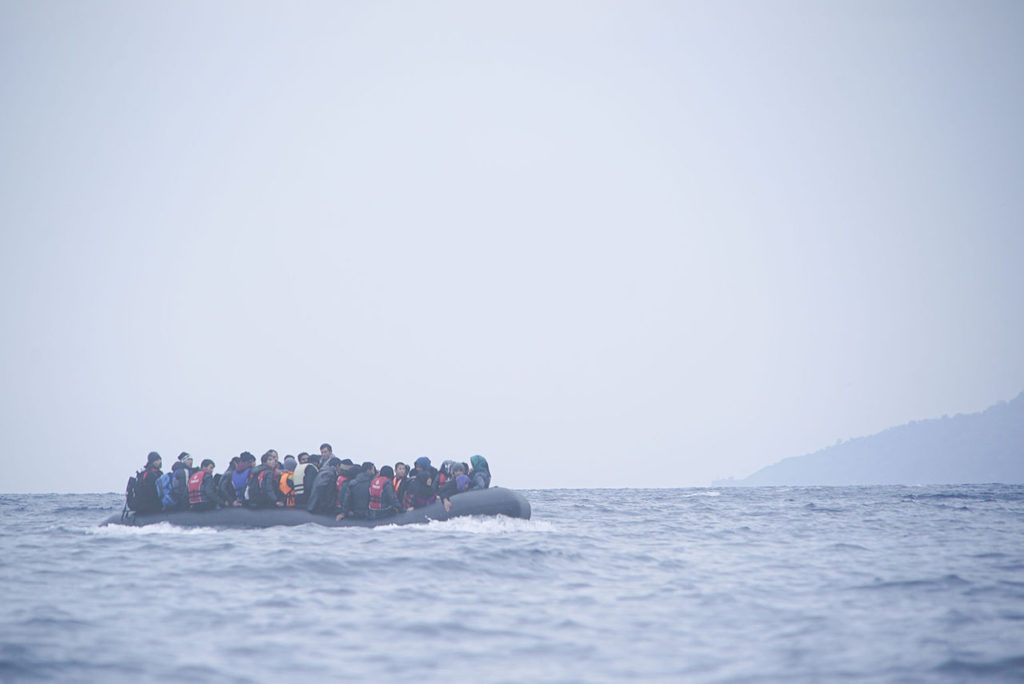Refugees cross the Mediterranean sea on a boat in January 2016, heading from Turkish coast to Greece. (Photo via Wikimedia Commons)