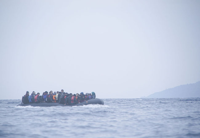 Refugees cross the Mediterranean sea on a boat in January 2016, heading from Turkish coast to Greece. (Photo via Wikimedia Commons)