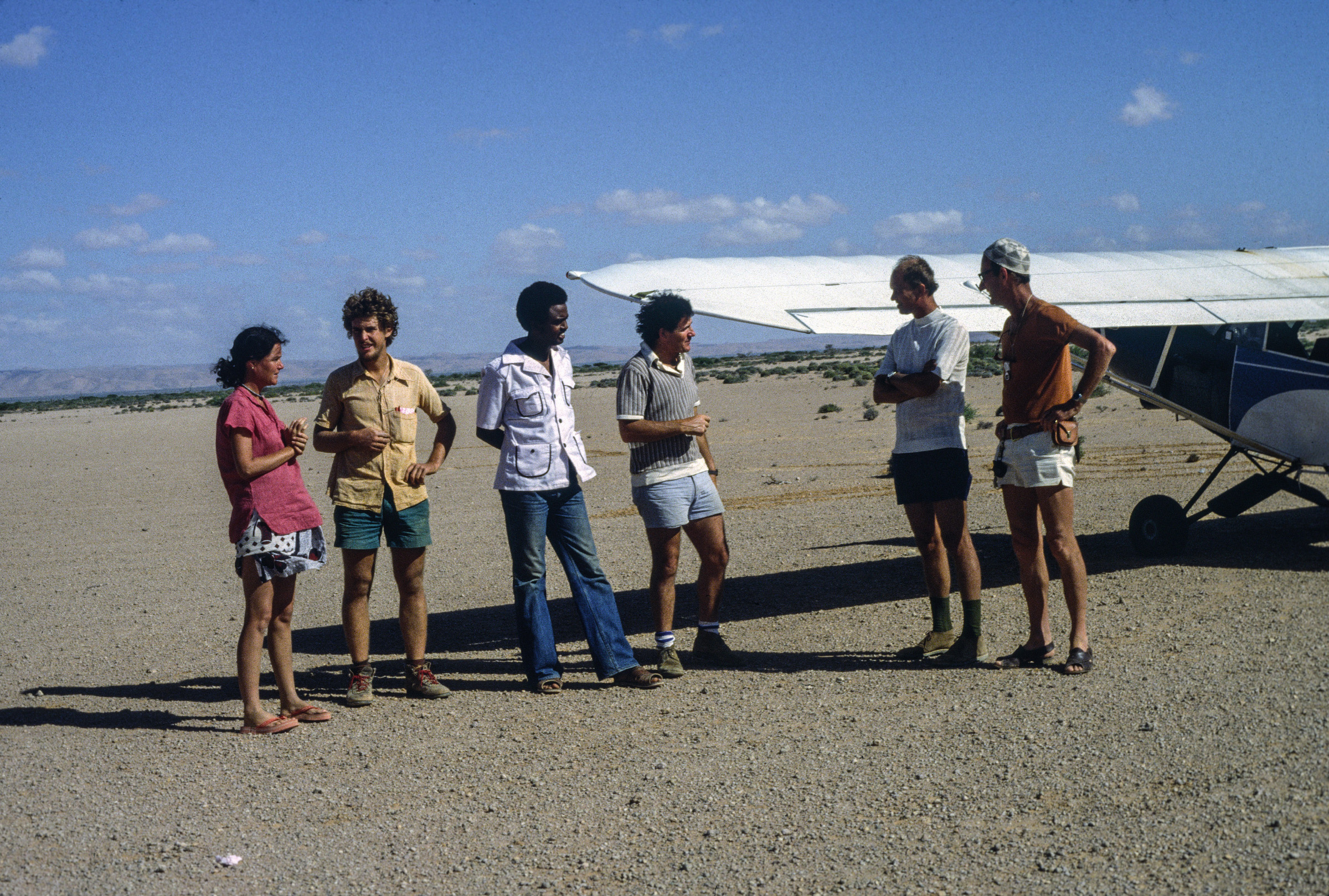Watson and his researchers stand on a tarmac in Somalia. Archival Photo.