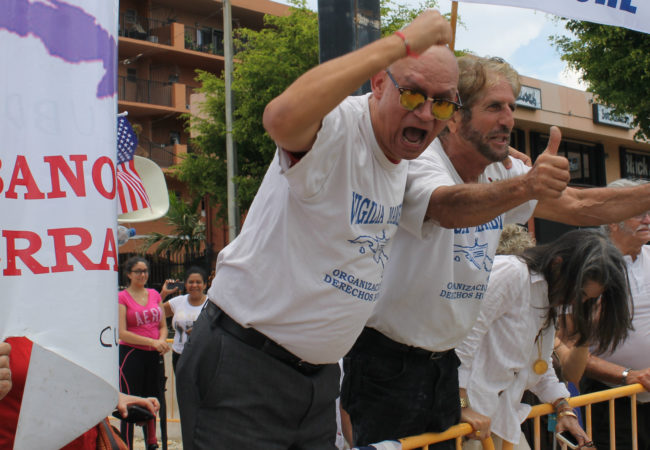 This group of Cuban-Americans in Miami, who support President Donald Trump's decision to restrict business and travel between the U.S. and Cuba, duel with a group of Cuban-Americans who oppose the move. (Amaury Sablon/GroundTruth)