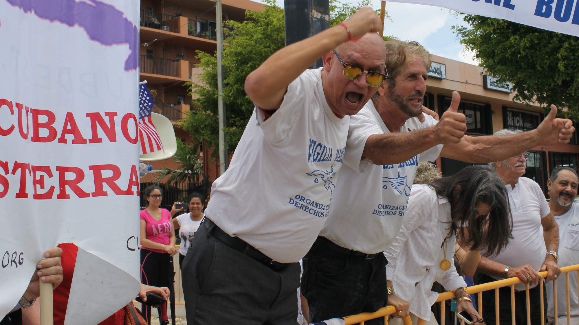 This group of Cuban-Americans in Miami, who support President Donald Trump's decision to restrict business and travel between the U.S. and Cuba, duel with a group of Cuban-Americans who oppose the move. (Amaury Sablon/GroundTruth)