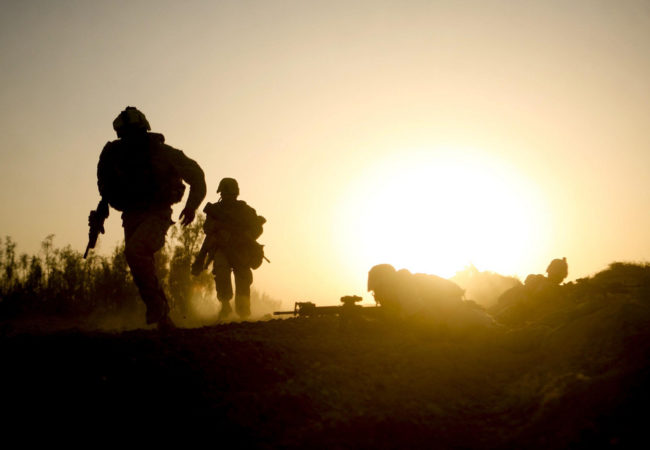 Marines with Company B, 1st Battalion, 5th Marine Regiment, Regimental Combat Team 3, run for cover during a fire fight in Nawa District, Helmand province, Afghanistan, Oct. 2, 2009. Dave Philipps covers veterans issues, and found out about suicidal veterans who had served in Afghanistan through a social media group they used. (Lance Cpl. John McCall via ISAF Public Affairs/Flickr Creative Commons)