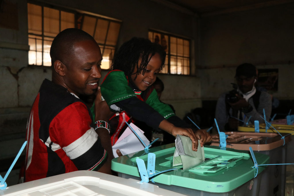 Boniface Mwangi, a 34-year-old journalist turned activist ran for Parliament. He cast his vote with his family at Juja Road Primary School in Nairobi, Kenya on August 8, 2017. (Neha Wadekar/GroundTruth)