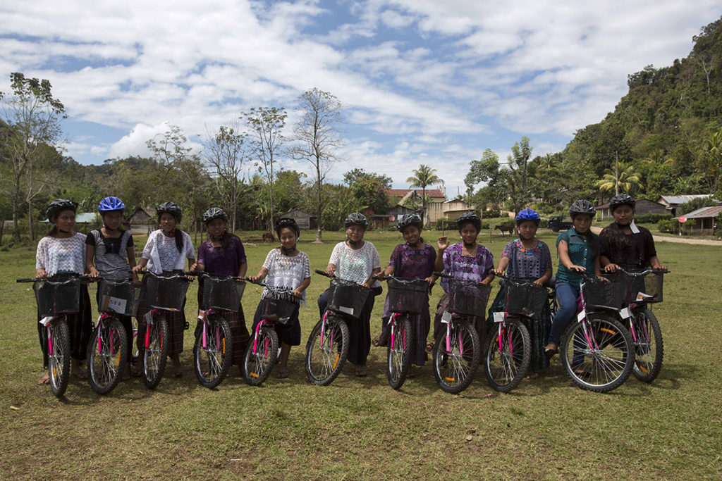 Girls in Chisec, Guatemala, receive bicycles from an initiative started by GroundTruth's Lauren Bohn, SchoolCycle. Bicycles allow girls to more easily travel to school, and give them autonomy over their own movement. (Lauren Bohn/GroundTruth)