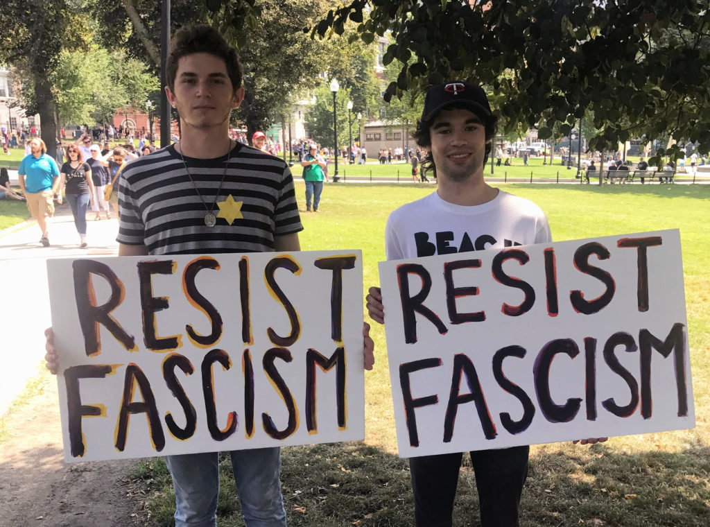 David Velona (left) and his friend protest the self-described Free Speech Rally on Boston Common. (Karolina Chorvath/GroundTruth)