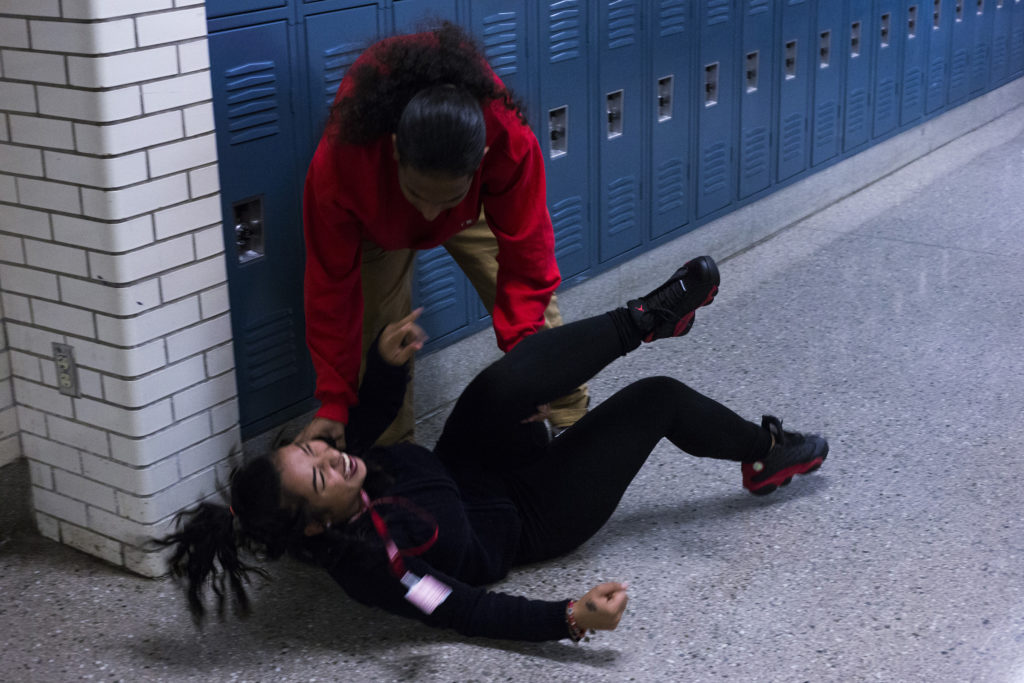Anthony Castillo, 18, playfully swings around Greysey Gomez Ortiz, 18, in the hallway between their classes at the High School of Commerce in Springfield, Mass., on Monday, September, 11, 2017. (Photo by Brittany Greeson)