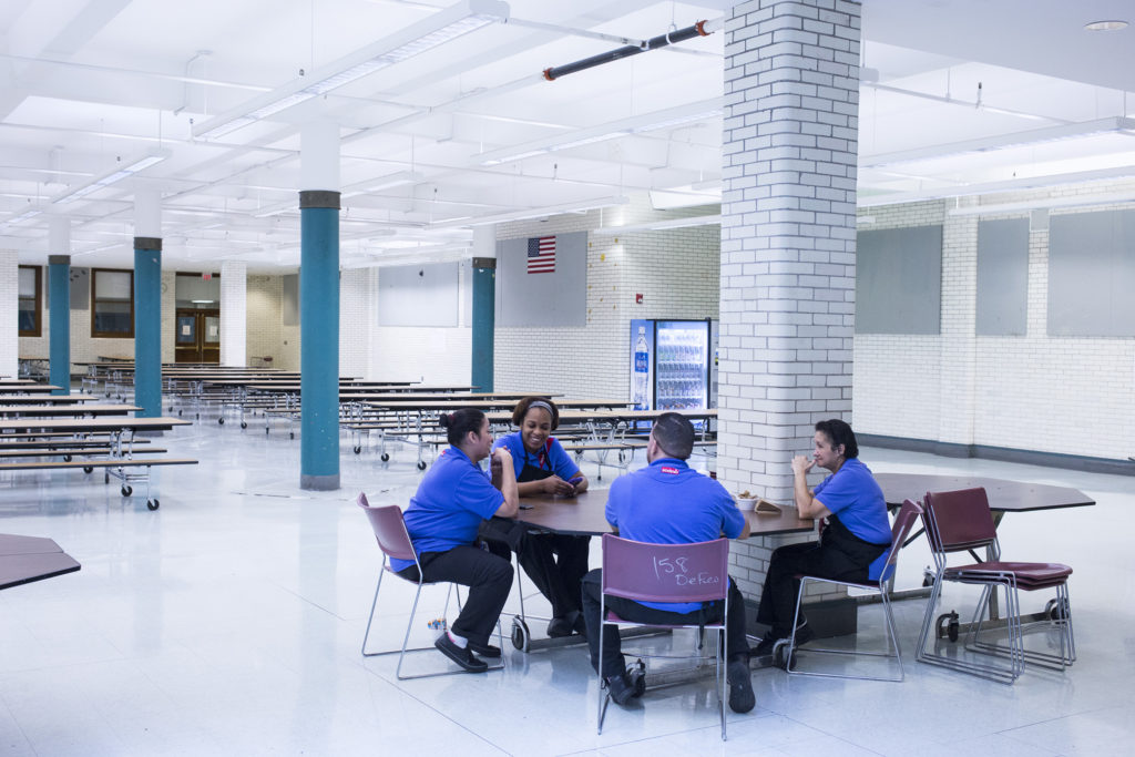 Selina Torres, center, talks with other cafeteria staff members during a break before lunch is served at the High School of Commerce in Springfield, Mass., on Monday, September, 11, 2017. (Photo by Brittany Greeson)