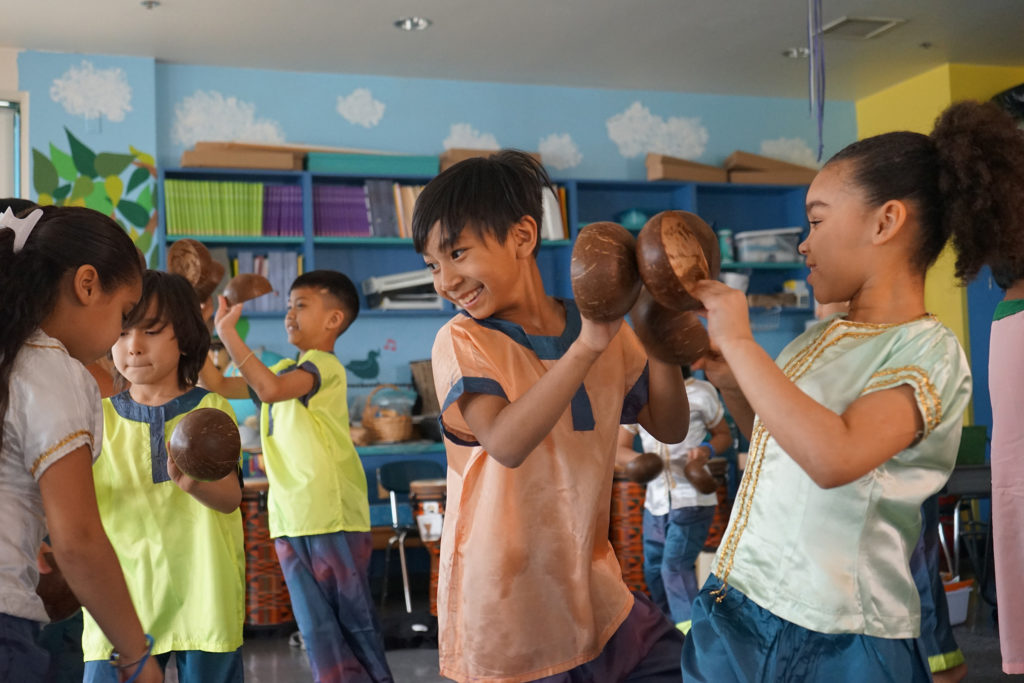 Irish American music teacher Rita Laughlin teaches kids in Lowell, Massachusetts, how to play traditional Cambodian instruments. Here, fourth graders practice the Coconut Dance in costume. (Photo by Heidi Shin)