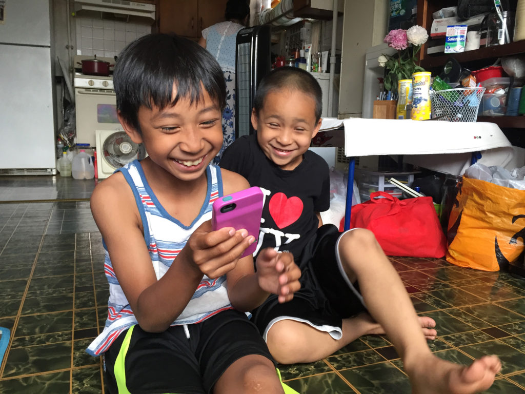 Nine-year old Maddox uses an app to help translate the words he doesn’t know in Cambodian when he accompanies his grandmother to her doctor’s visits, where she’s treated for symptoms of PTSD. (Photo by Heidi Shin)