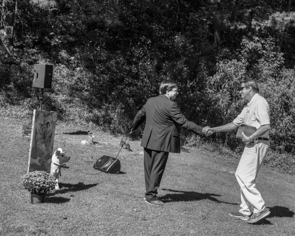 Ron McCoy (left) and Billy Hatfield shake hands at the former Randolph McCoy cabin site, which was attacked by a group of Hatfield men in 1888. (Photo by Ben Brody)