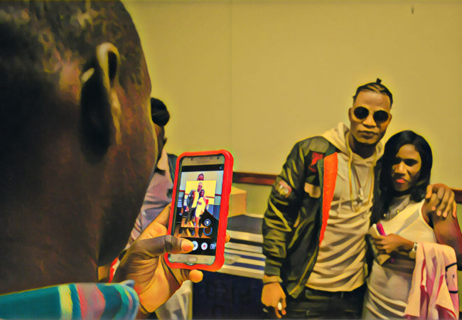 Vladimir Mead, who performs under the name Masterbrain, poses with fans after a show in Brockton, Massachusetts. (Photo by Ian Coss with Prisma filter)