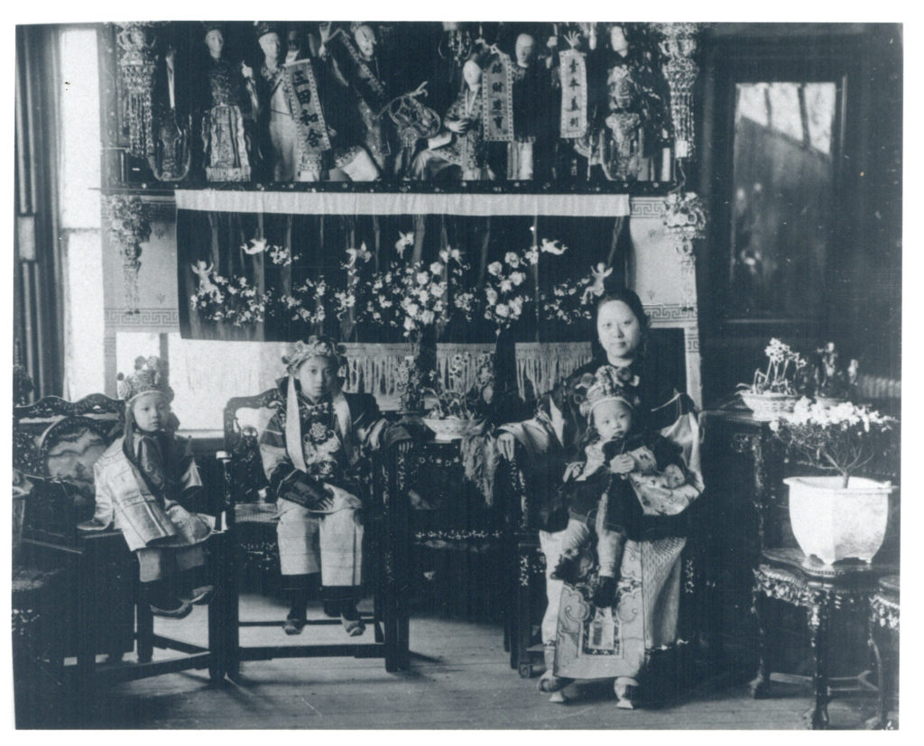 A Chinese family at their home on Harrison Avenue in Boston circa 1920. (Boston City Archives/Flickr)