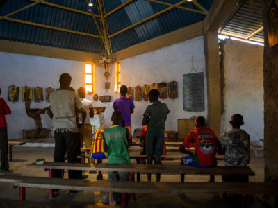 Father Florian gives an afternoon service in Illeret, Kenya. He took his vows at St. Ottilien Archabbey, where he adopted the Benedictines' unofficial motto, “Ora et Labora” — “Pray and Work.” This has become his mantra for his time with Kenya's ethnic Daasanach community, one of the smallest tribes in Kenya. (Christena Dowsett/The GroundTruth Project)