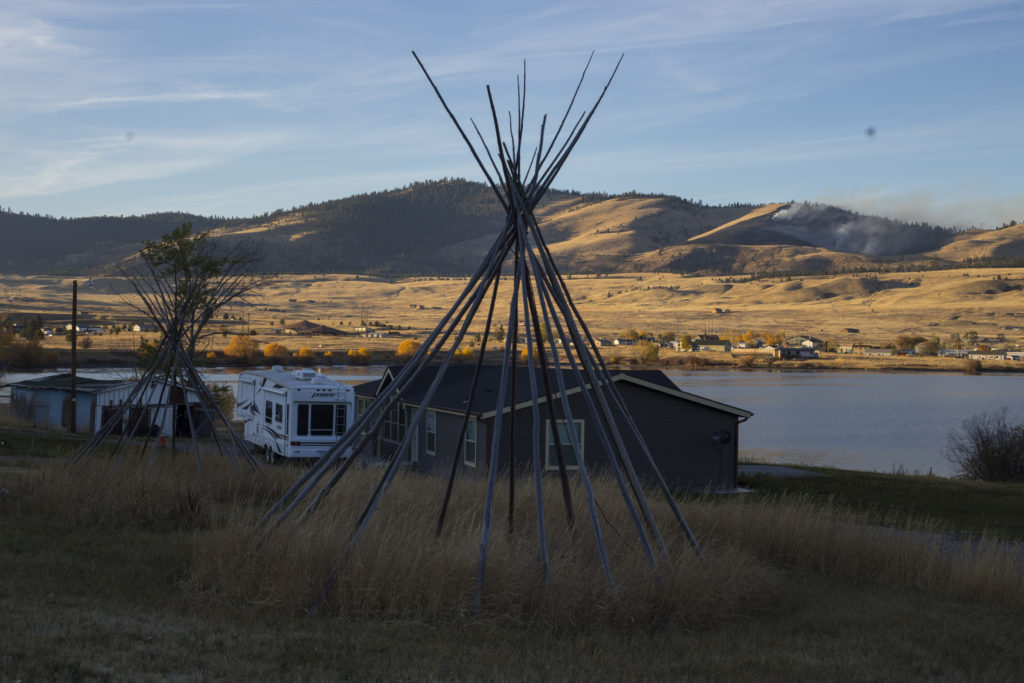 A teepee stands in a residential area of Elmo, Montana, as a prescribed burn overseen by the Confederated Salish and Kootenai Tribe's Divison of Fire fades out on Tuesday, October 24, 2017. (Photo by Brittany Greeson)