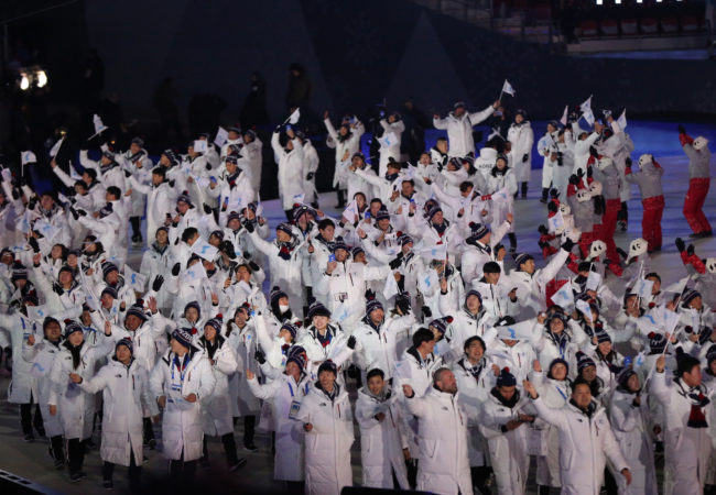Athletes from South Korea and North Korea enter the Olympic stadium on February 9, 2018, under a unity flag depicting the Korean peninsula. (Andy Miah/Flickr Creative Commons)