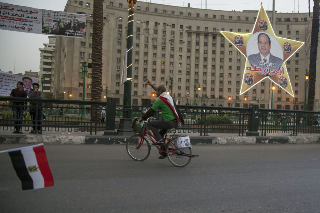 A supporter of Abdel Fattah el-Sisi campaigns for the president in Tahrir Square ahead of the election today. (Roger Anis/GroundTruth)