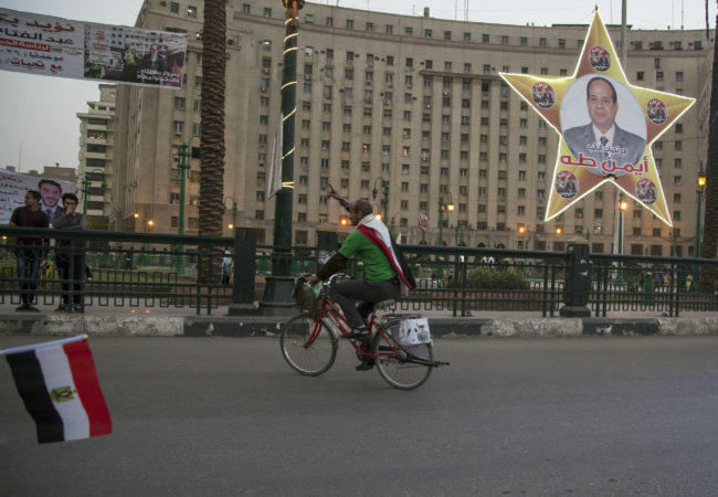 A supporter of Abdel Fattah el-Sisi campaigns for the president in Tahrir Square ahead of the election today. (Roger Anis/GroundTruth)