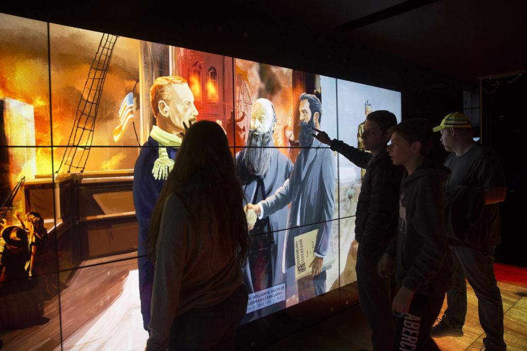 Visitors at an interactive exhibit in the Visionaries Gallery of the Friends of Zion Museum in Jerusalem on March 29,2018. (Heidi Levine/ The GroundTruth Project)