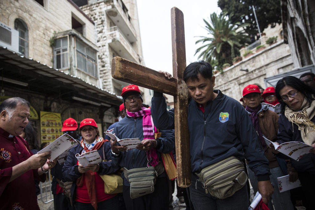 Christian worshippers from around the world along the Via Dolorosa as they walk towards the Church of the Holy Sepulchre on Good Friday, March 30, 2018, in Jerusalem's Old City. Christians believe it to be the site of the crucifixion of Jesus Christ. (Heidi Levine/The GroundTruth Project)