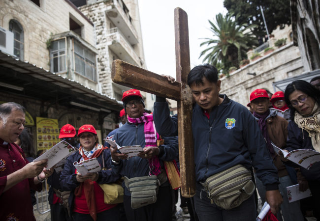 Christian worshippers from around the world along the Via Dolorosa as they walk towards the Church of the Holy Sepulchre on Good Friday, March 30, 2018, in Jerusalem's Old City. Christians believe it to be the site of the crucifixion of Jesus Christ. (Heidi Levine/The GroundTruth Project)