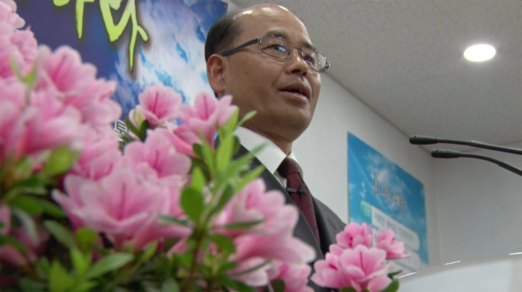 Pastor Gang Suk Jin prepares his sermon at Tongil Chon’s only church. (Aziza Kasumov/GroundTruth)