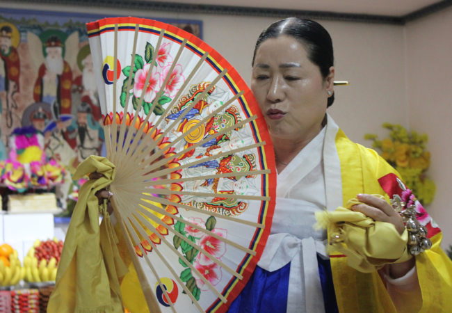 With political instability and an economic downturn, Koreans are turning to traditional shamanic ceremonies. (Miranda Mazariegos/GroundTruth)