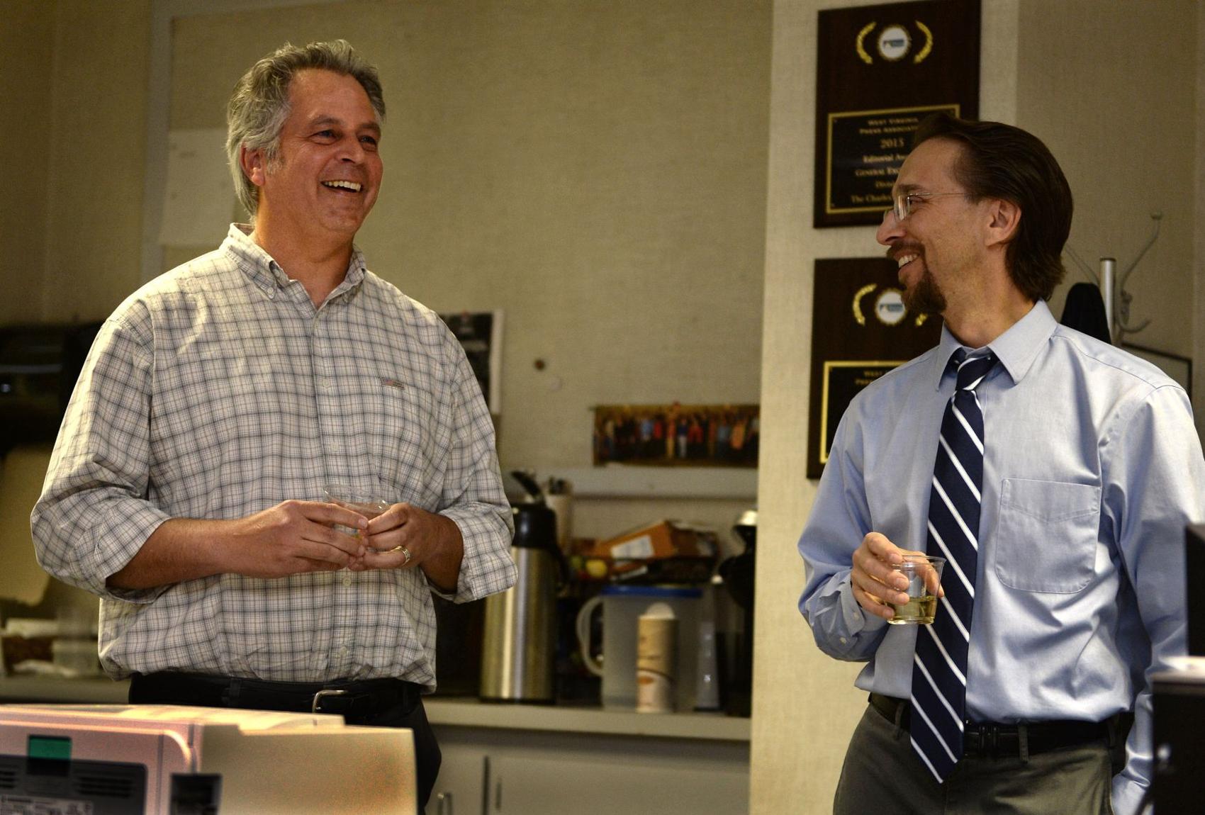 Gazette-Mail reporter Eric Eyre (left) talks with then-Executive Editor Rob Byers in the Charleston Gazette-Mail newsroom after Eyre won the 2017 Pulitzer Prize for investigative reporting.