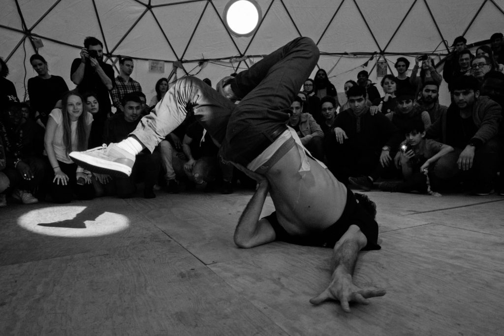 Visiting artist Sofian Jouini breakdances in The Dome during the March 3 Hope Show. (Photo by Annabelle Marcovici/GroundTruth)