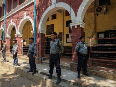 Myanmar Police officers stand on guard outside a courtroom in Insein Township during Wa Lone and Kyaw Soe Oo's trial.