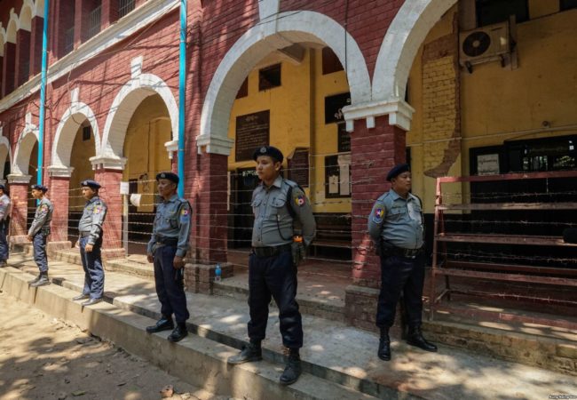 Myanmar Police officers stand on guard outside a courtroom in Insein Township during Wa Lone and Kyaw Soe Oo's trial.